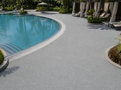 Resort pool surround finished in light rubber surfacing